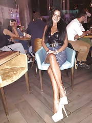 Tanned Leggy Brunete In Leather Top Denim Skirt And Shite Pumps