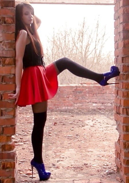 Cool Nymph Posing Outdoors In Red Mini Skirt & Blue Shiny Ankle Boots